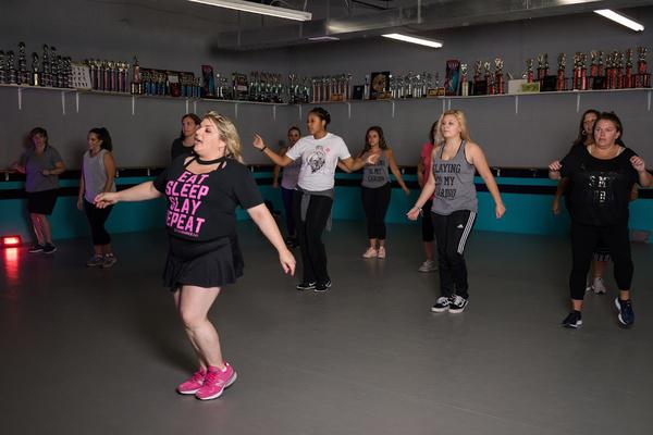 Women participating in a DivaDance choreography class in a mirrored studio